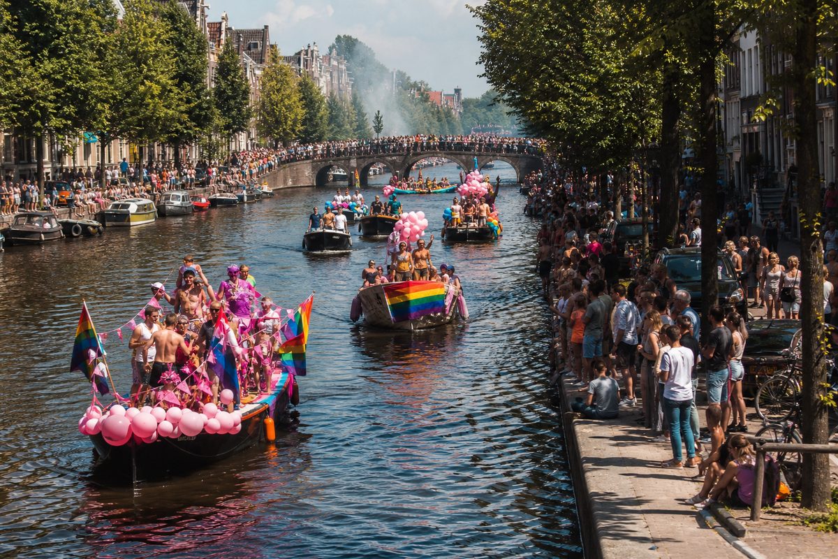 Crowds watching decorated boats during the Amsterdam Canal Parade